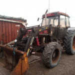 tractor in front of a red container